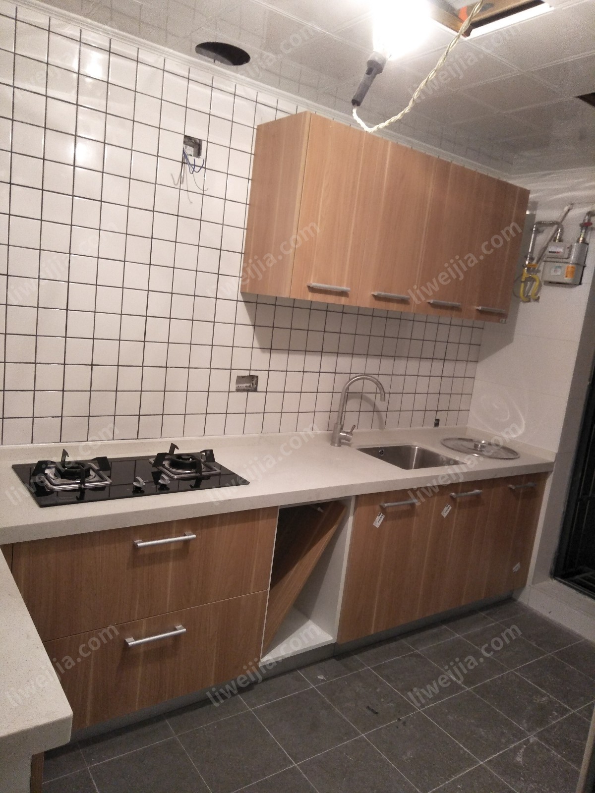 这是一个比较标准的L字厨房，各个功能分区得到了有效的区分，柜子装好后，活动的空间还是很充裕的。